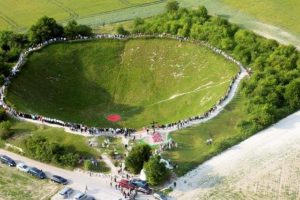 Lochnagar Crater, during one of the remembrance ceremonies, during which visitors are encouraged to join hands around the lip of the crater.