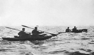 Two two man canoes at sea