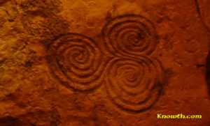 Triskelion on orthostat C10 in the north recess at the back of the chamber at New Grange is probably the most famous Irish Megalithic symbol. Photo Credit- Knowth.com